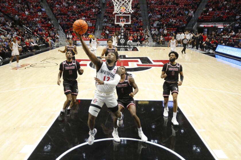 San Diego, CA - December 5: San Diego State's Darrion Trammell (12) scores against Troy at Viejas Arena on Monday, December 5, 2022. (K.C. Alfred / The San Diego Union-Tribune)
