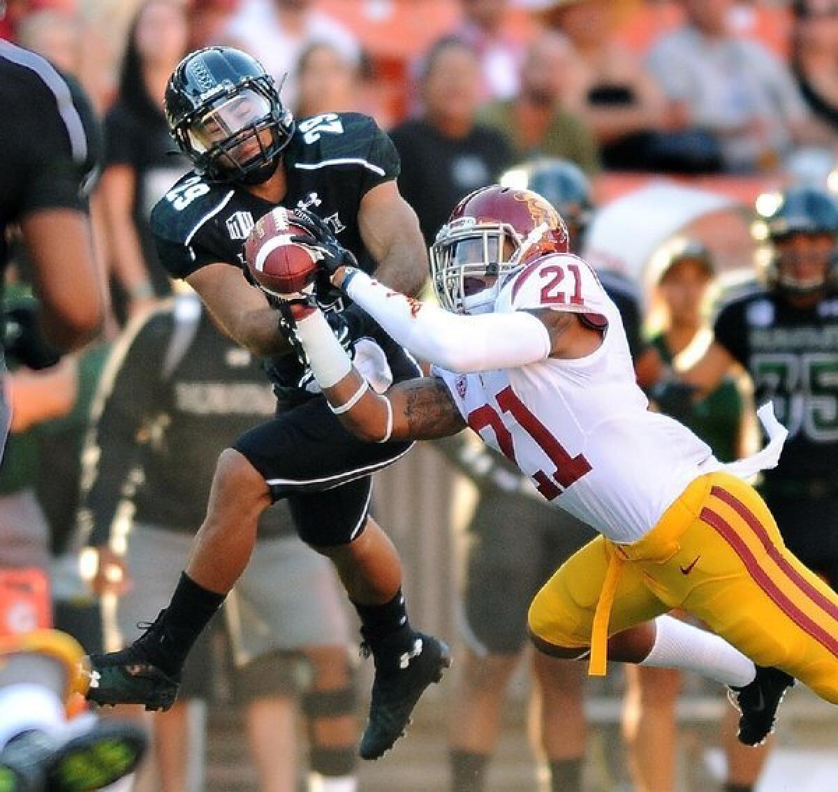 USC's Su'a Cravens intercepts a pass in front of Hawaii receiver Scott Harding in the first quarter.