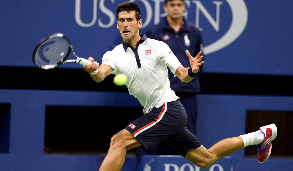 Novak Djokovic hits a return to Roberto Bautista Agut during their U.S. Open match on Sunday.