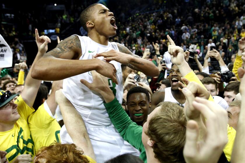 Oregon guard Joseph Young is hoisted by fans after the Ducks defeated No. 9 Utah on Sunday in Eugene, Ore.
