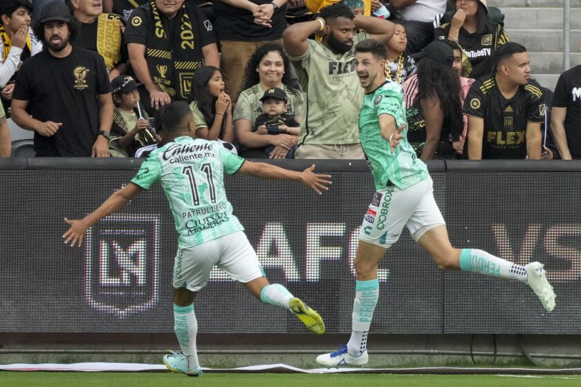León midfielder Lucas Di Yorio, right, celebrates with midfielder Elias Hernandez (11) after scoring a goal against Los Angeles FC during the first half in the second leg of a CONCACAF championship final soccer match, Sunday, June 4, 2023, in Los Angeles. (AP Photo/Marcio Jose Sanchez)