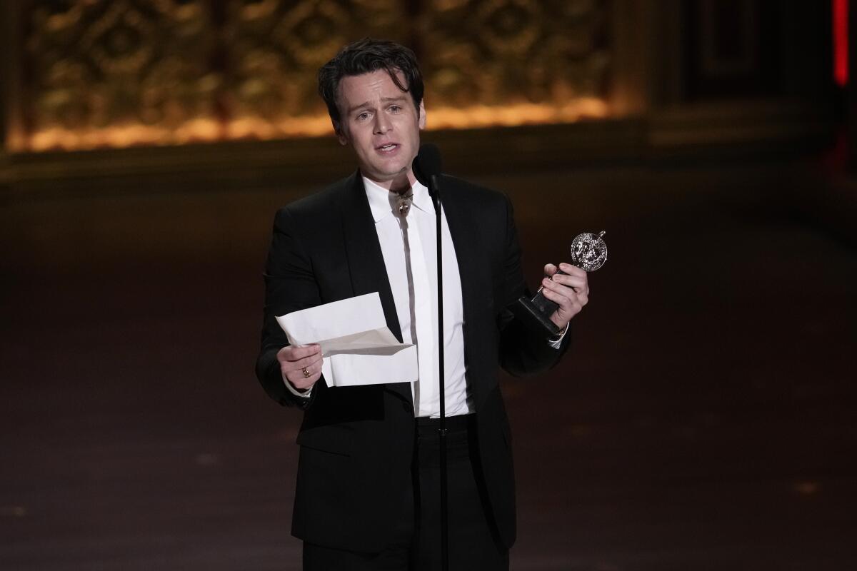 An emotional Jonathan Groff accepts the award for lead actor in a musical for "Merrily We Roll Along."