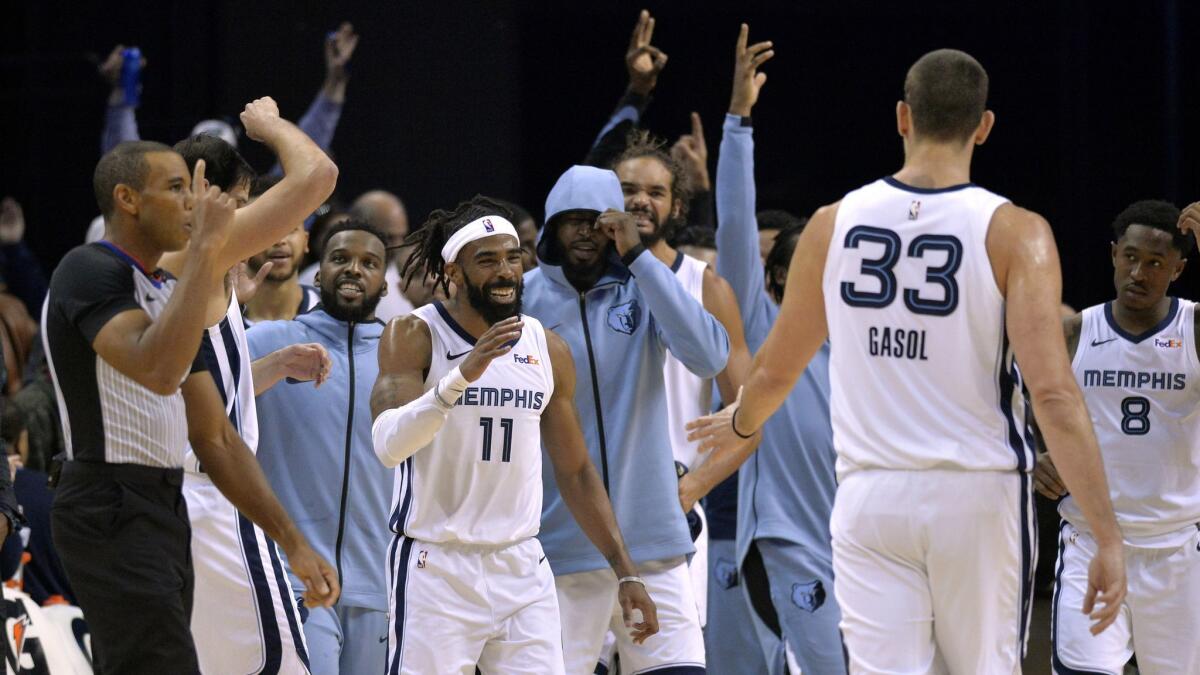 Teammates react after Memphis Grizzlies guard Mike Conley (11) made a three-pointer to beat the buzzer at the end of the first half against the Clippers.