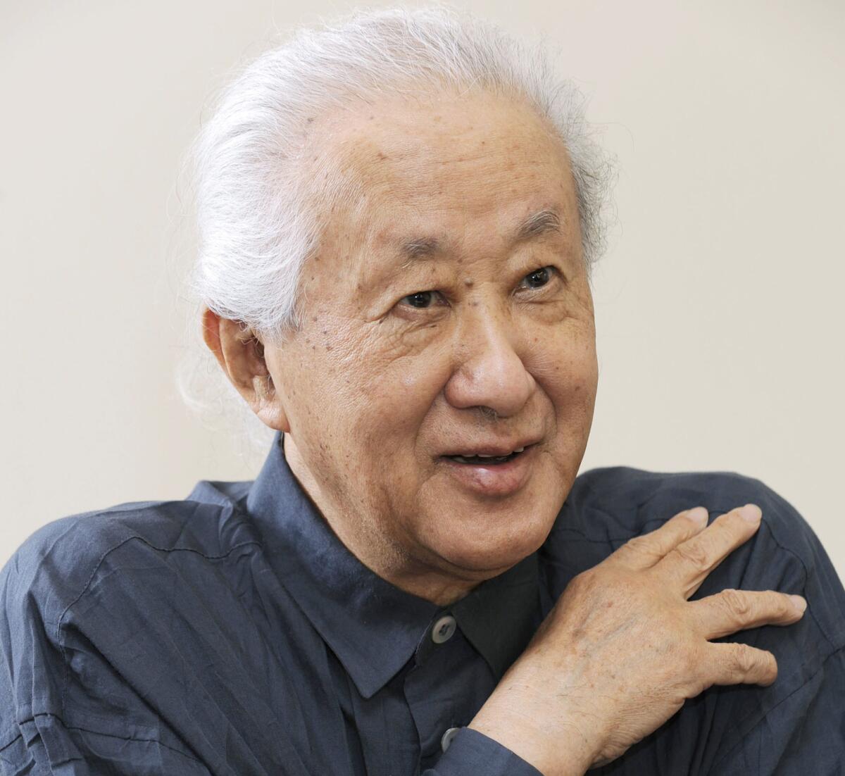 FILE- Architect Arata Isozaki is interviewed in 2013. Isozaki, a Pritzker-winning Japanese architect known as a post-modern giant who blended culture and history of the East and the West in his designs, has died of old age. He was 91. (Kyodo News via AP, File)