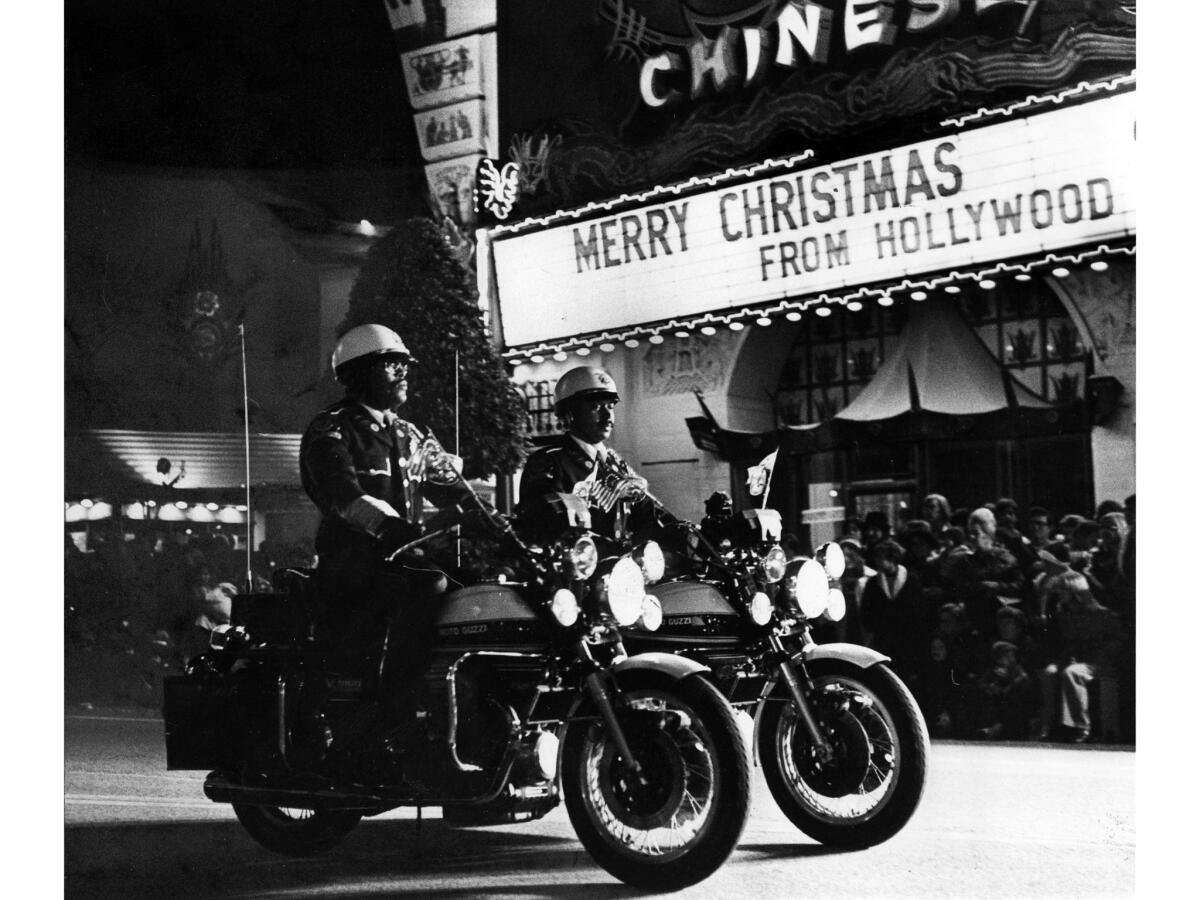 Nov. 28, 1976: Members of the Los Angeles Police Department motorcycle drill team lead the Santa Claus Lane Parade down Hollywood Boulevard. The parade had 17 floats and 13 marching bands.