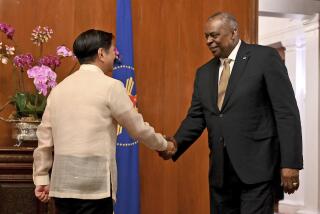U.S. Secretary of Defense Lloyd James Austin III, right, shake hands with Philippine President Ferdinand Marcos Jr. during a courtesy call at the Malacanang Palace in Manila, Philippines on Thursday, Feb. 2, 2023. (Jam Sta Rosa/Pool Photo via AP)