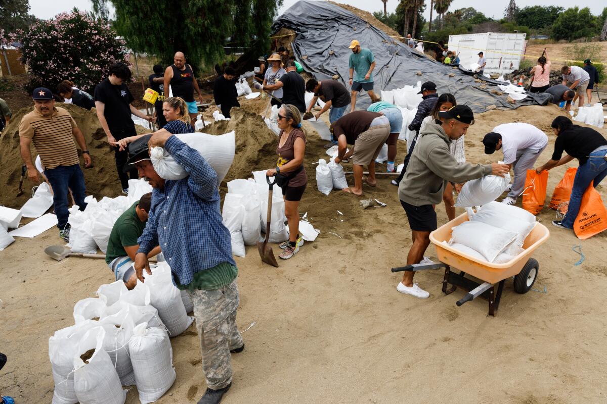 In preparation for the incoming storm from Hurricane Hilary, residents fill sandbags at the Bonita-Sunnyside Fire Protection