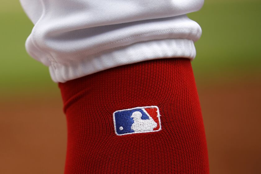 FILE - The Major League Baseball Logo is seen on Washington Nationals' Trea Turner's sock as he prepares for an at-bat during an interleague baseball game against the Chicago White Sox, June 5, 2019, in Washington. The U.S. Justice Department asked a federal appeals court to narrowly consider Major League Baseball’s antitrust exemption, a filing made in a case involving four eliminated minor league teams hoping to eliminate the sport’s century-old legal protection. (AP Photo/Patrick Semansky, file)