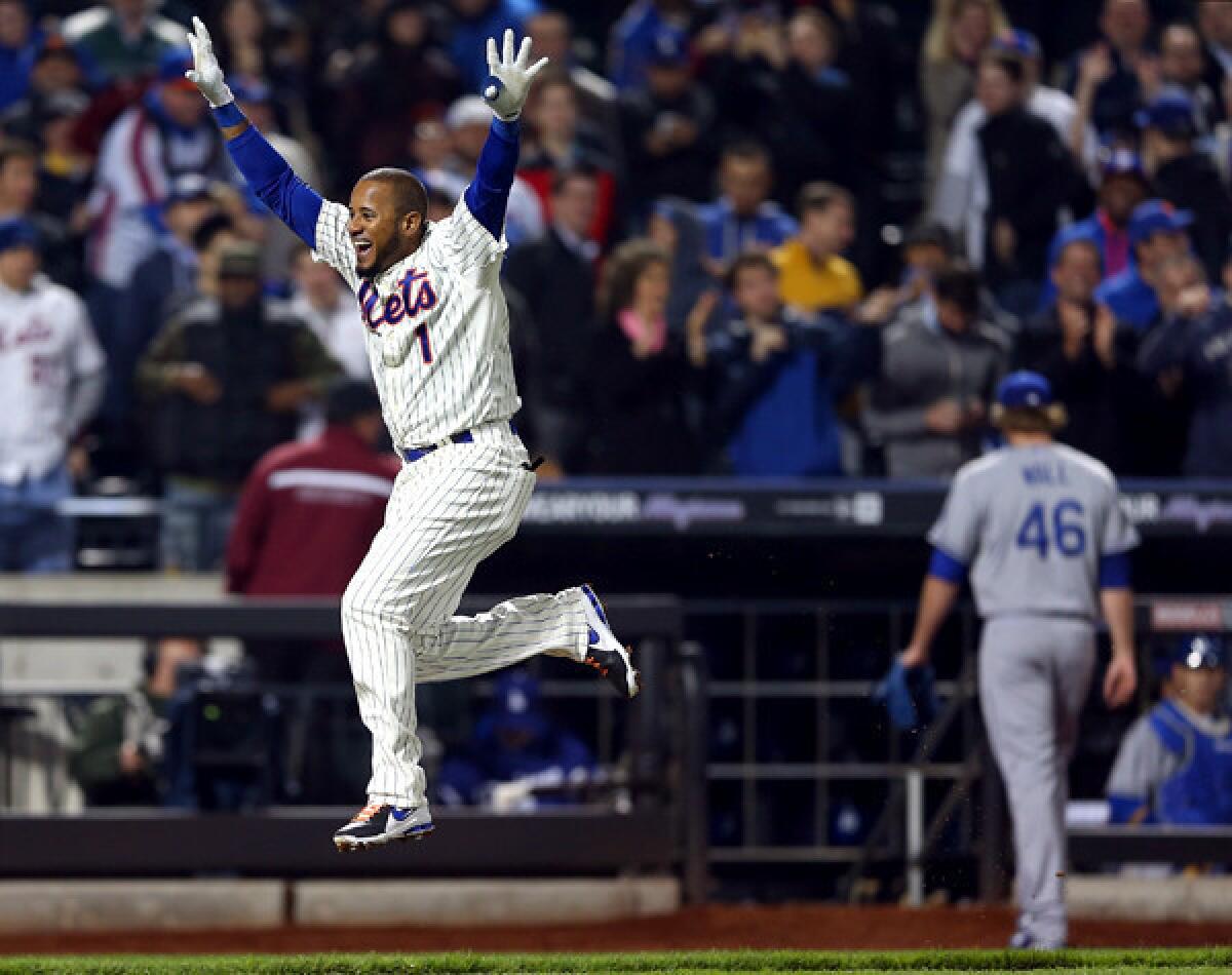 Mets center fielder Jordany Valdespin celebrates as he leaps toward home plate after hitting a game-winning grand slam off Dodgers reliever Josh Wall (46) in the 10th inning Wednesday night in New York.