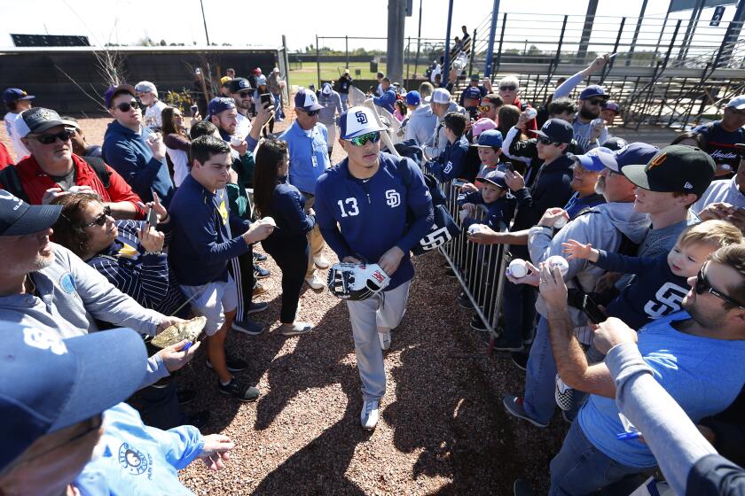 San Diego Padres infielder Manny Machado signs autographs after a spring training practice on Feb. 23, 2019. (Photo by K.C. Alfred/San Diego Union-Tribune)