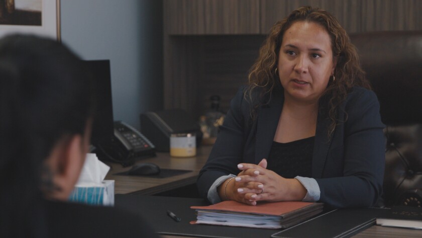 Alma Puente talks to Claudia, a wife and mother of two whose husband was taken into custody.