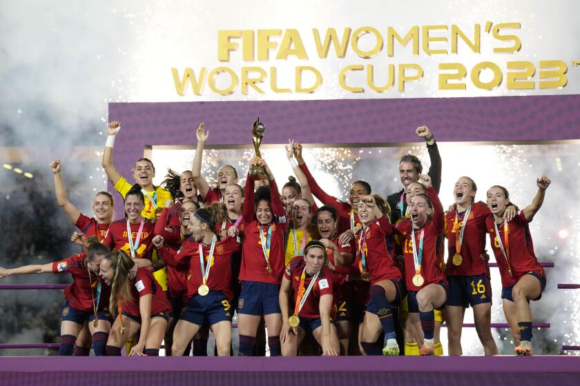 Team Spain celebrates with the trophy after winning the Women's World Cup soccer final against England at Stadium Australia in Sydney, Australia, Sunday, Aug. 20, 2023. (AP Photo/Alessandra Tarantino)