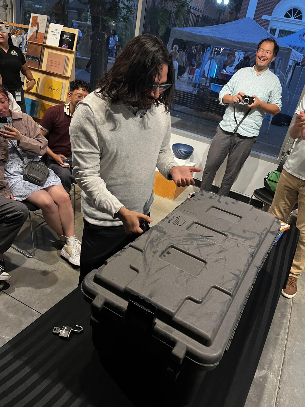 Manny Escamilla prepares to open a time capsule packed in 2014 at Grand Central Art Center.