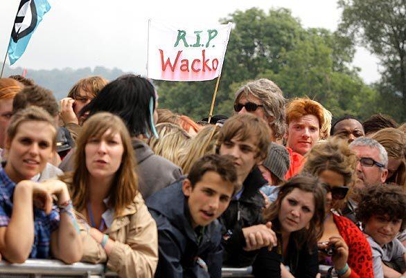 Festival goers hold a banner aloft at the Glastonbury festival in Glastonbury, England, after the death of Michael Jackson in Los Angeles at age 50.