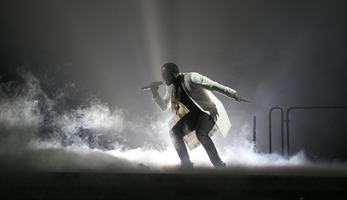 Sean Combs, known as Puff Daddy, performs Tuesday night at the Forum.