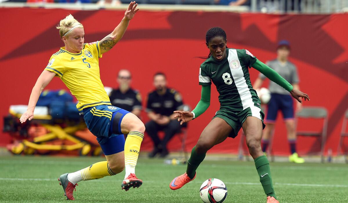 Nigeria's forward Asisat Oshoala, right, kicks the ball to score a goal as Sweden's defender Nilla Fischer tries to stop during a match of the 2015 FIFA Women's World Cup on Monday.