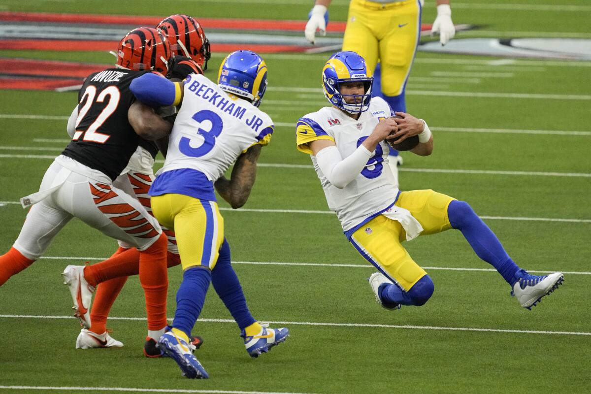 Rams quarterback Matthew Stafford scrambles during the first half of Super Bowl LVI.