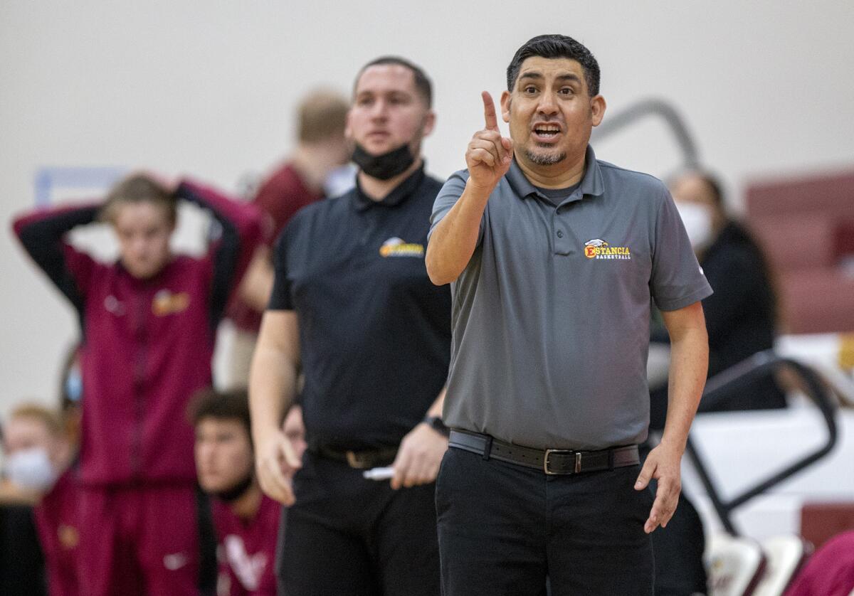 Estancia's Xavier Castellano gestures to his team during the first Battle for the Bell rivalry game against Costa Mesa.