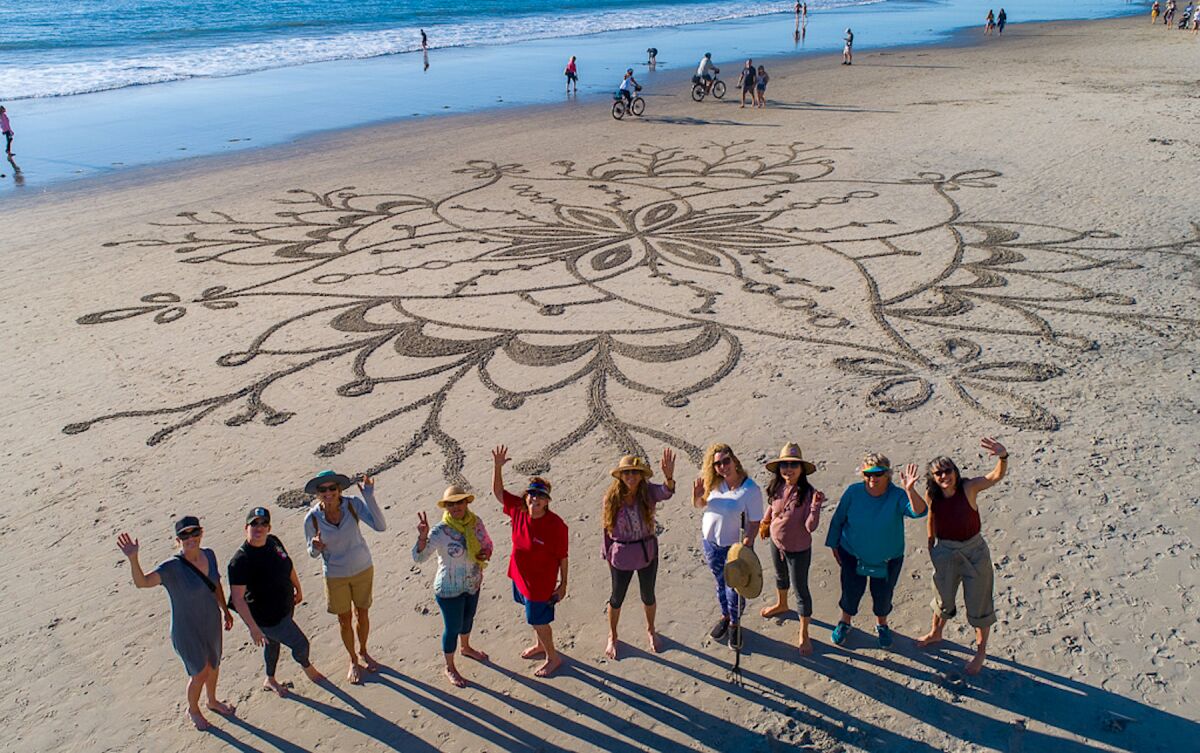A drone’s-eye view of workshop participants with their completed artwork.