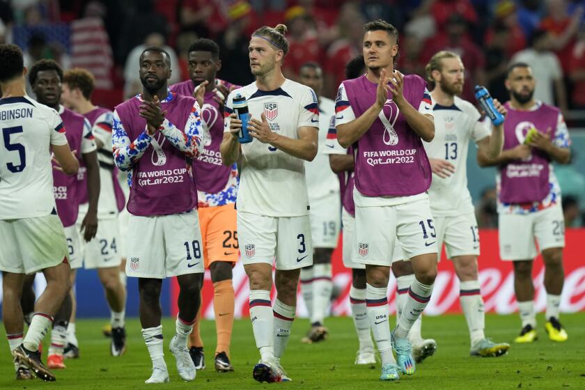 Shaq Moore, goalkeeper Sean Johnson, Walker Zimmerman and Aaron Long of the United States, center from left, applaud at the end of the World Cup, group B soccer match between the United States and Wales, at the Ahmad Bin Ali Stadium in Doha, Qatar, Tuesday, Nov. 22, 2022. The game ended in a 1-1 draw. (AP Photo/Francisco Seco)
