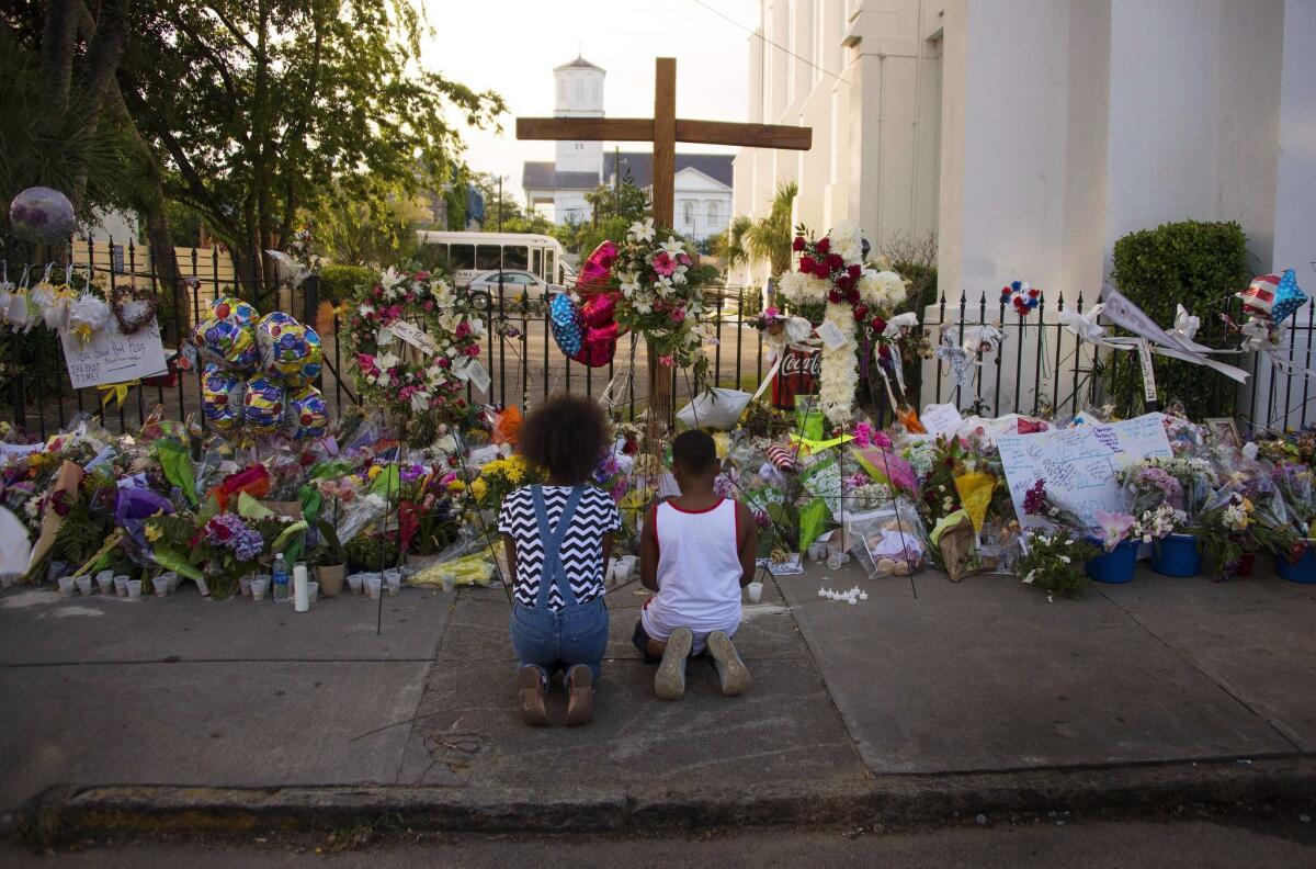 Two children pray outside Emanuel AME Church in Charleston, S.C. where nine churchgoers were shot dead during bible study on June 17.
