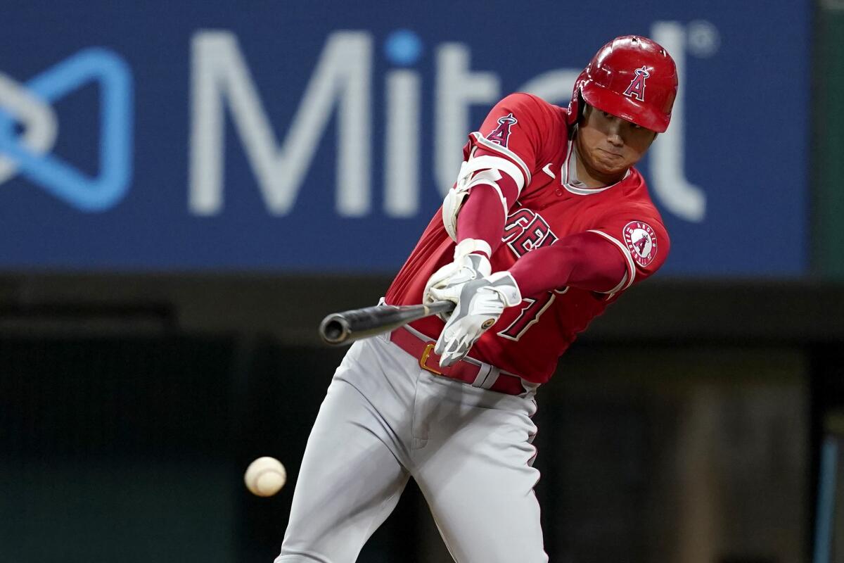 Angels' Shohei Ohtani connects for a single against the Texas Rangers.