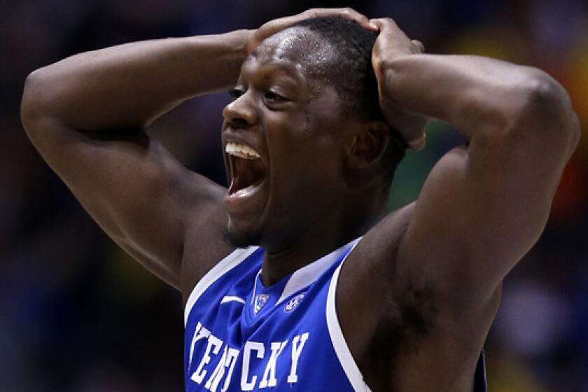 Kentucky's Julius Randle celebrates the Wildcats' 75-72 victory over Michigan in the Midwest Regional final of the NCAA tournament.