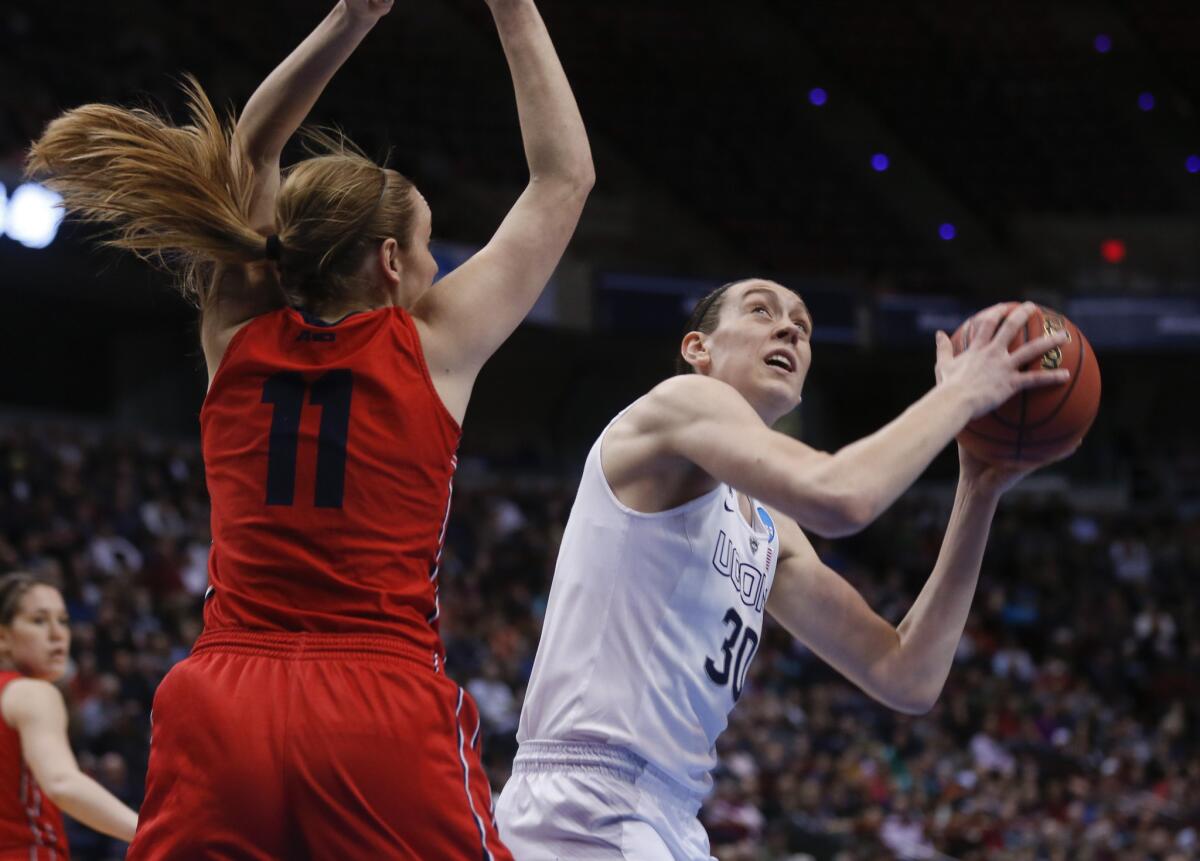 Connecticut forward Breanna Stewart shoots over Dayton forward Ally Malott. Stewart scored 23 points and grabbed 16 rebounds to help send the Huskies back to the Final Four.