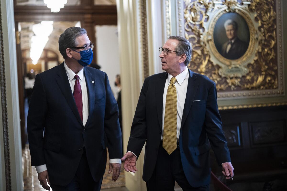 Bruce Castor and Michael van der Veen walk down a hall