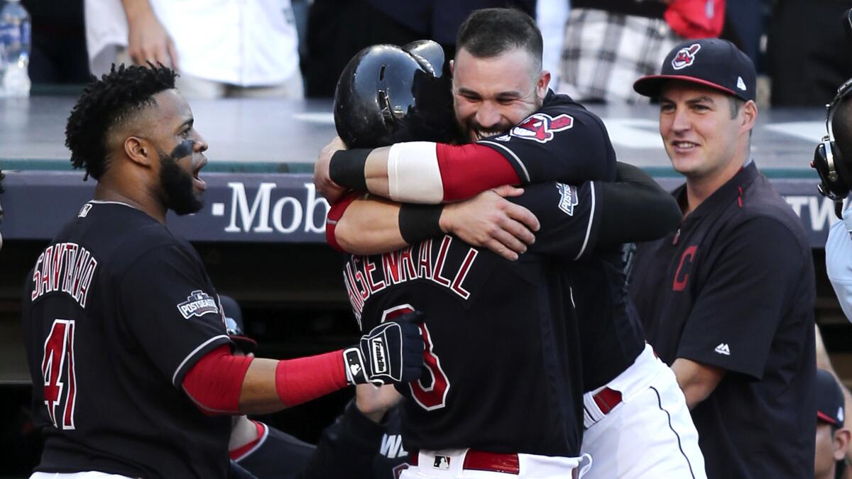 Indians right fielder Lonnie Chisenhall (center) is hugged by teammate Jason Kipnis (without cap) after hitting a three-run home run against the Red Sox in the second inning Friday.