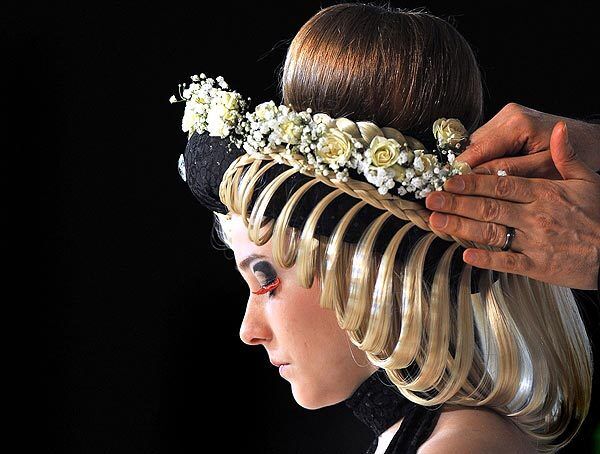A stylist works on a creation for the opening of the IX International Festival of Hairdresser Art in Kiev.
