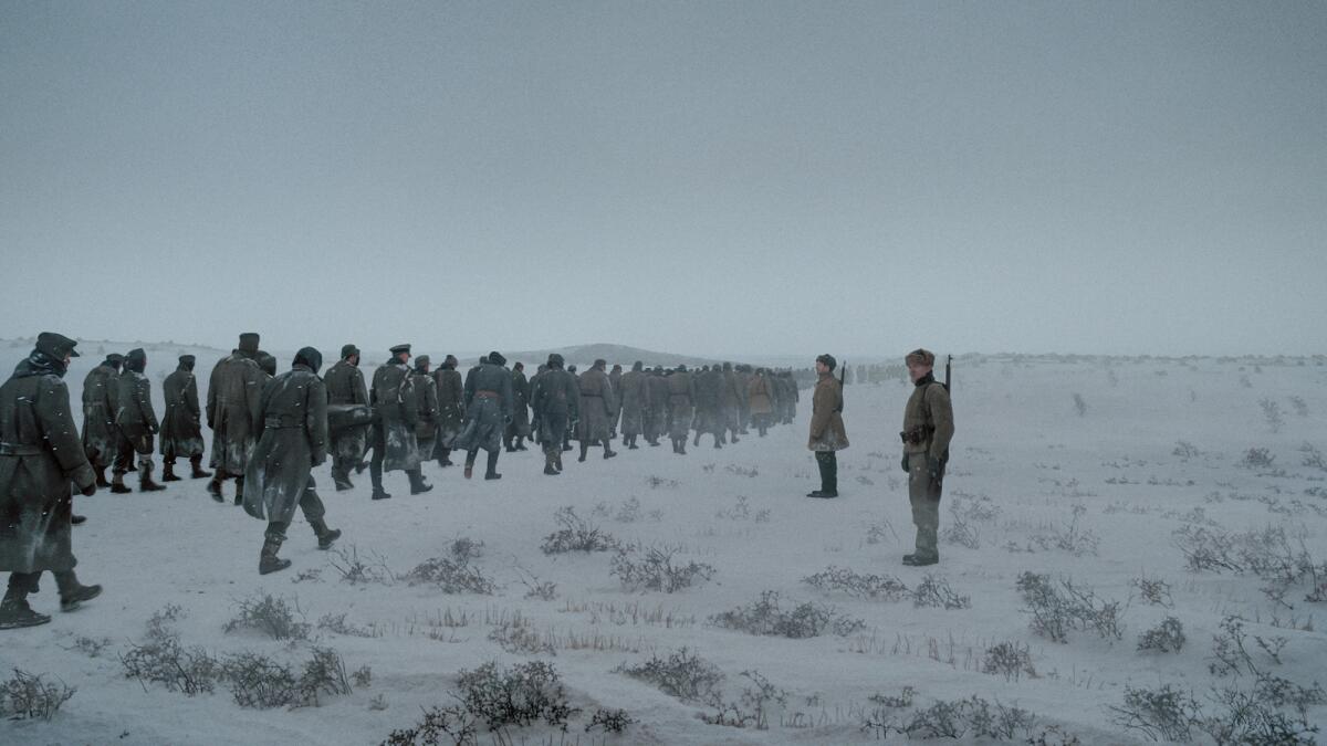 A scene of many men in gray coats walking in the snow from the movie "About Endlessness."