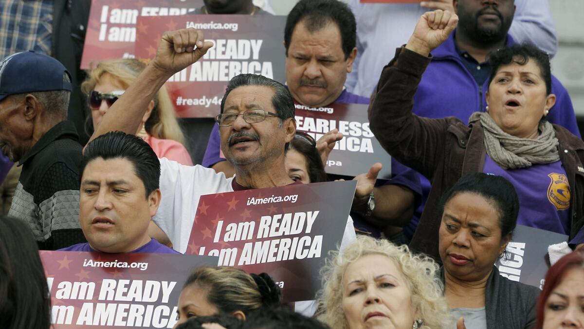 Community activists rally for programs that defer deporations during a Los Angeles event in February.