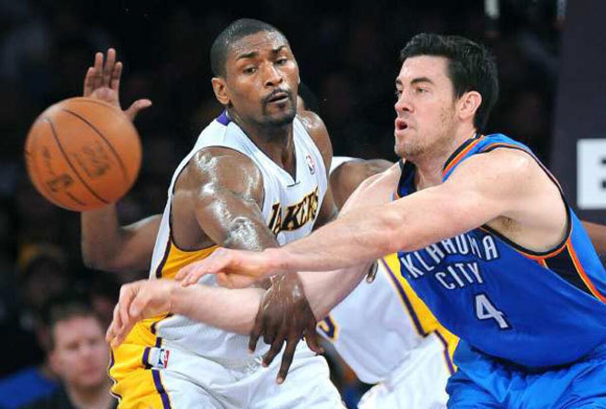 Metta World Peace, left, tries to steal the ball from Nick Collison during Sunday's Lakers game against Oklahoma City.