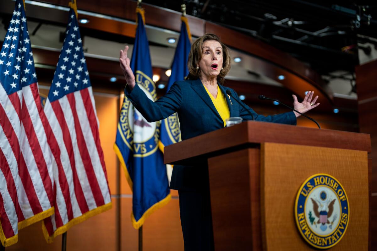 Speaker of the House Nancy Pelosi gestures while speaking at a news conference.
