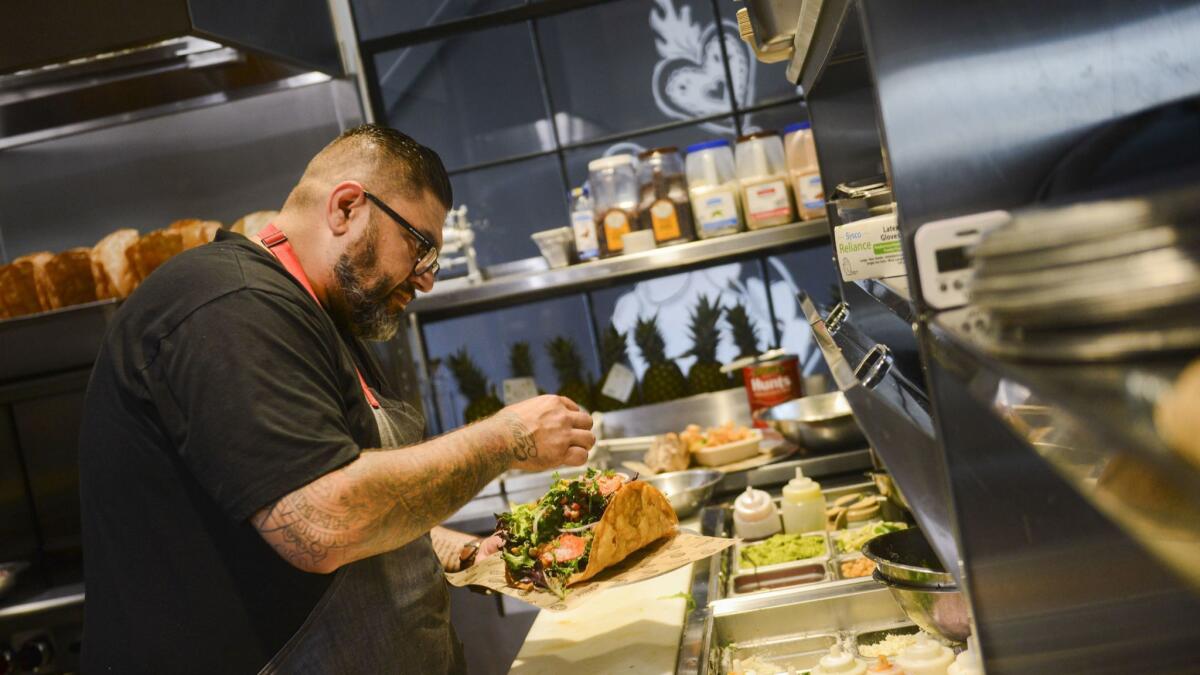 Chef Thomas Ortega prepares a taco salad at Amorcito, his fast-casual Mexican restaurant in Long Beach.