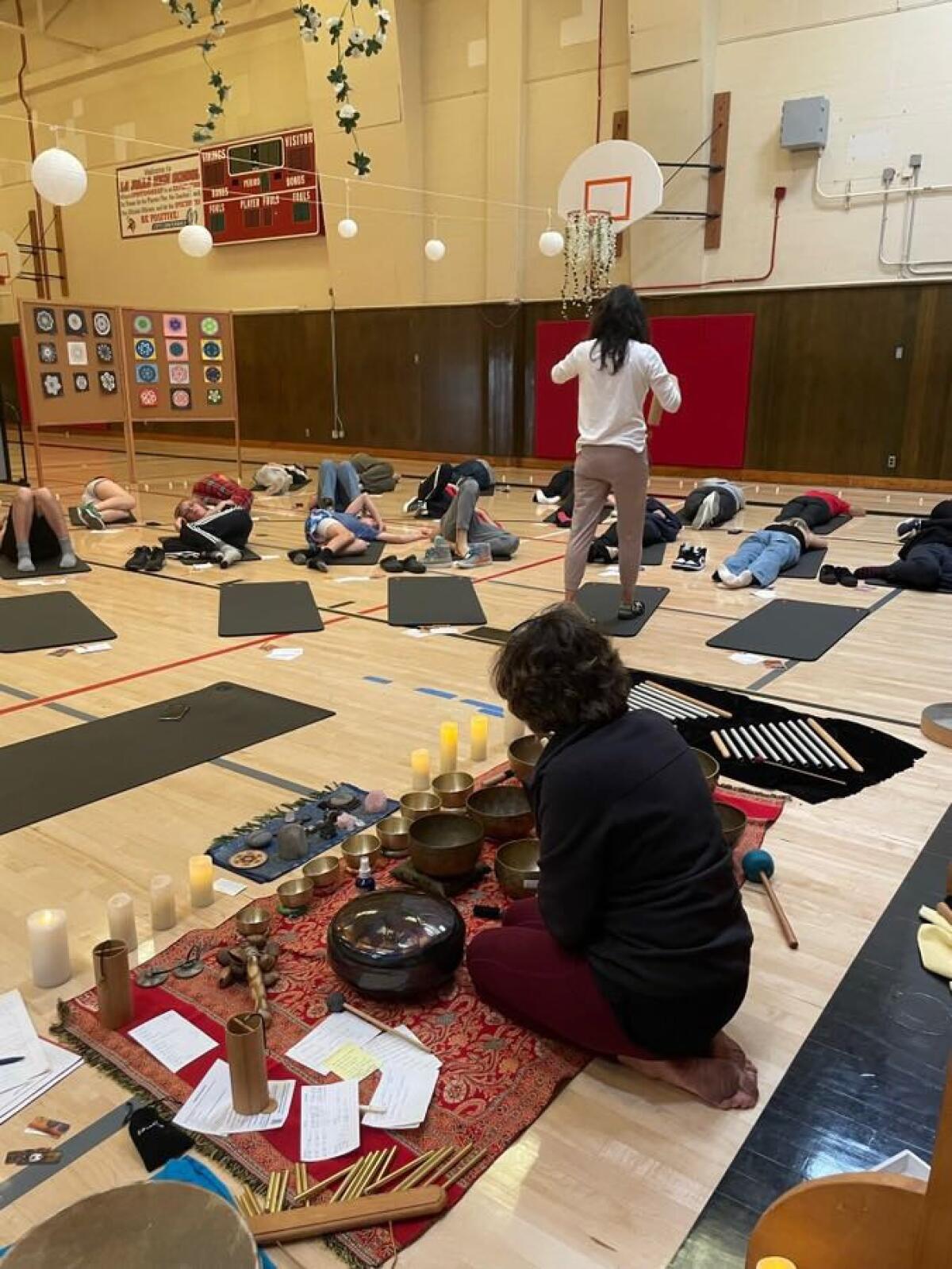 Life coach Linda Vazin (background) and Bird Rock artist Jane Wheeler lead a breathwork exercise at La Jolla High School.