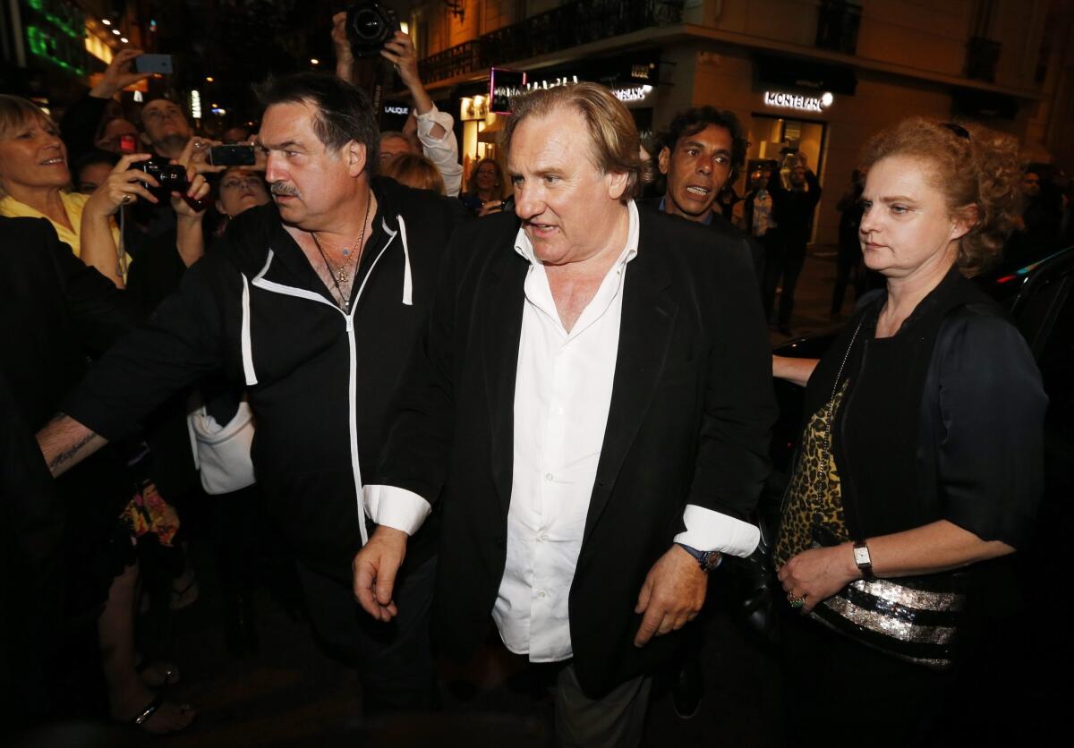French actor Gerard Depardieu, center, arrives for the screening of "Welcome to New York" in Cannes, France.