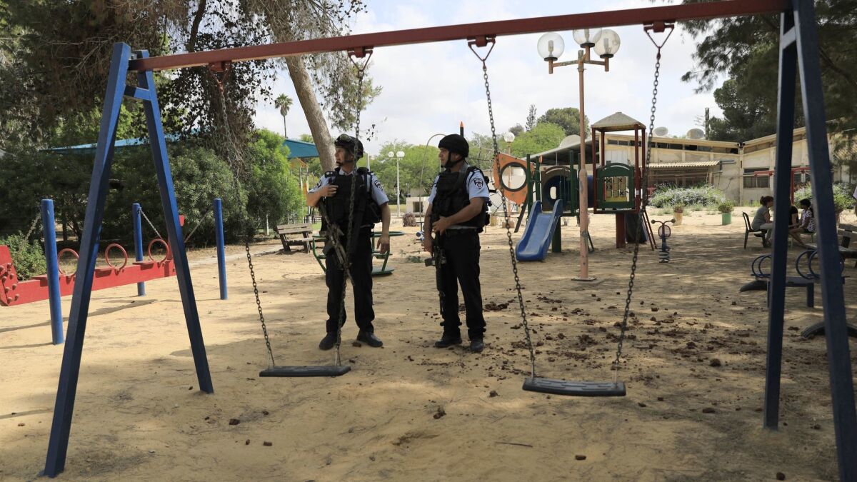 Israeli police officers guard a playground in a kibbutz near the border between Israel and Gaza May 29.