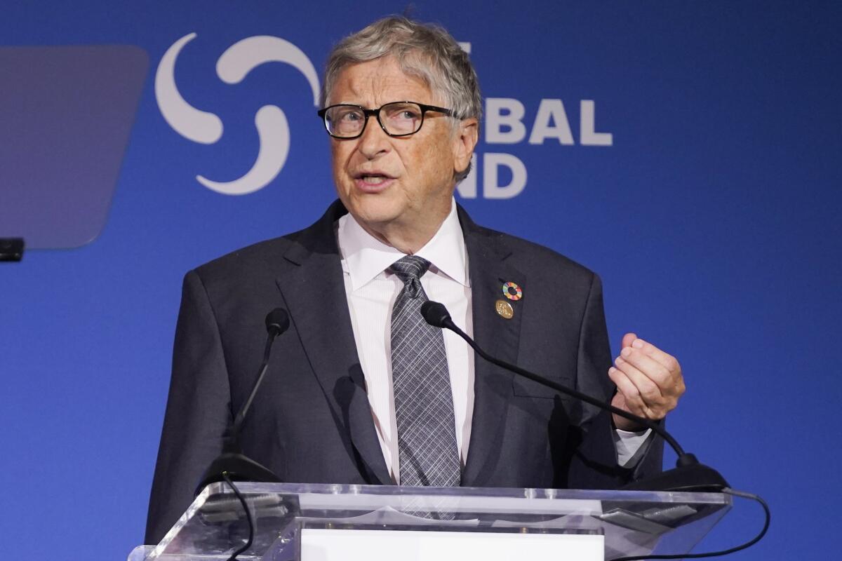 A man speaks at a lectern.