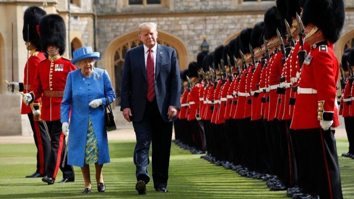Queen Elizabeth II walks with President Trump last July during a visit to Windsor Castle in England.