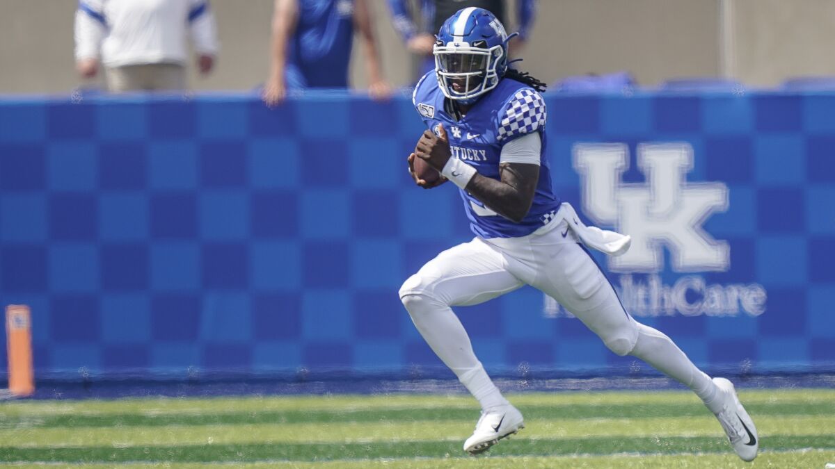 FILE - Kentucky quarterback Terry Wilson (3) carries the ball against Toledo during an NCAA college football game, Saturday, Aug., 31, 2019, in Lexington, Ky. An offense that relied heavily on Lynn Bowden’s running aims to pass more again with QB Terry Wilson’s return from a season-ending left knee injury sustained in last year’s second game. (AP Photo/Bryan Woolston, File)