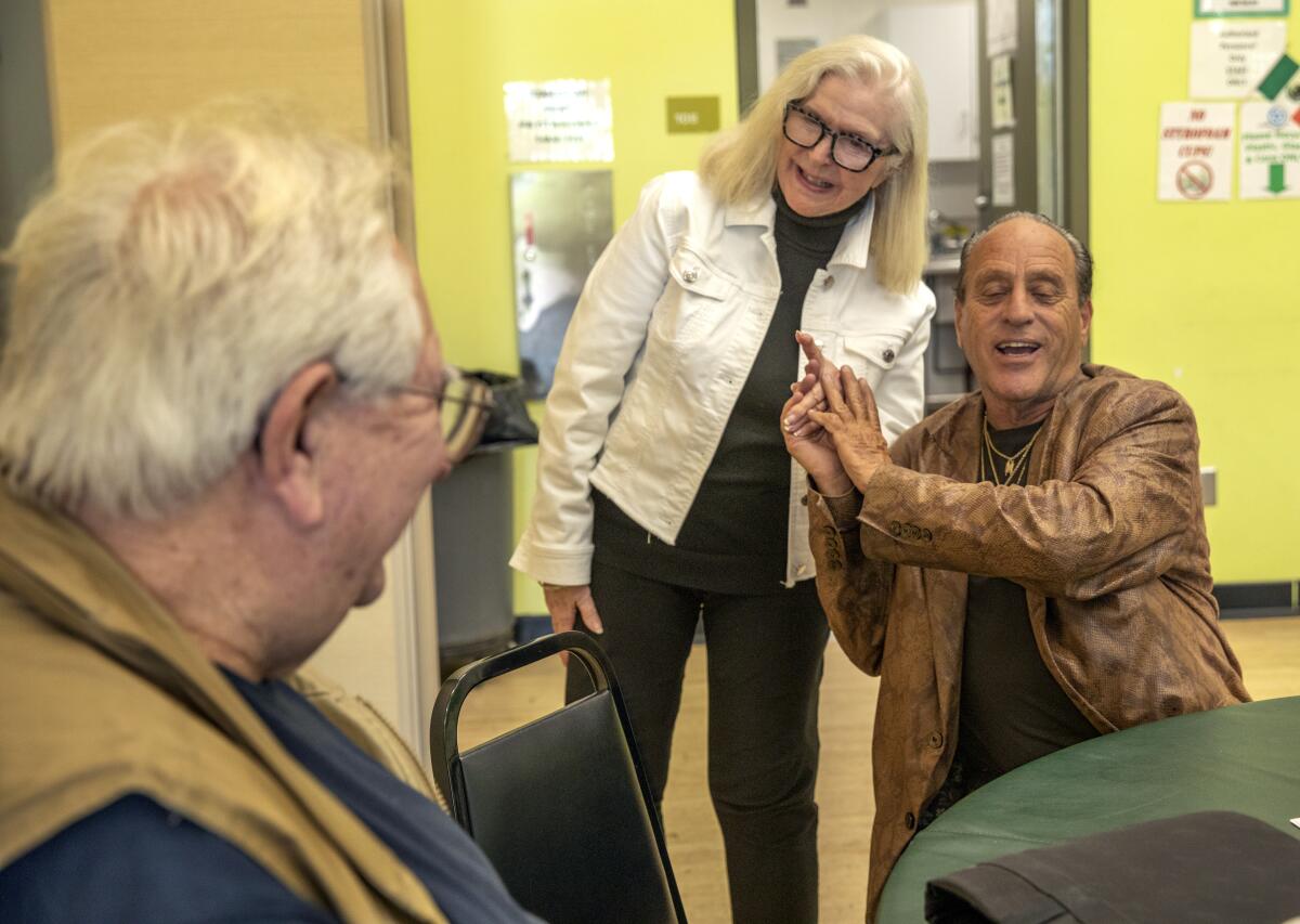 Beverly Ventriss, President/CEO of the Valley InterCommunity Council, talks with clients Stanley Goldstein and Israel Vamos. 
