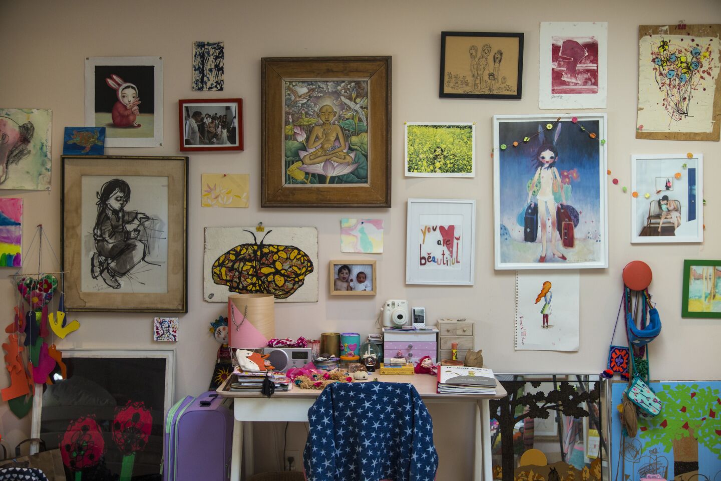 An art-filled salon wall in 7-year-old Fanny's bedroom