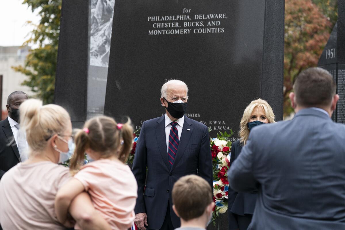 President-elect Joe Biden and his wife, Jill, greet guests after placing a wreath at the Philadelphia Korean War Memorial.
