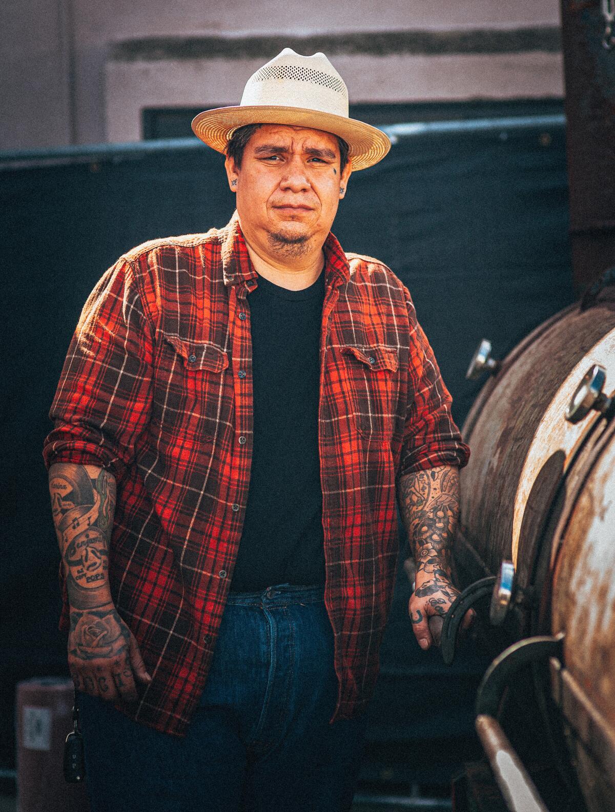 Pitmaster and owner Daniel Castillo stands next to a 1,000-gallon offset smoker at Heritage Barbecue.