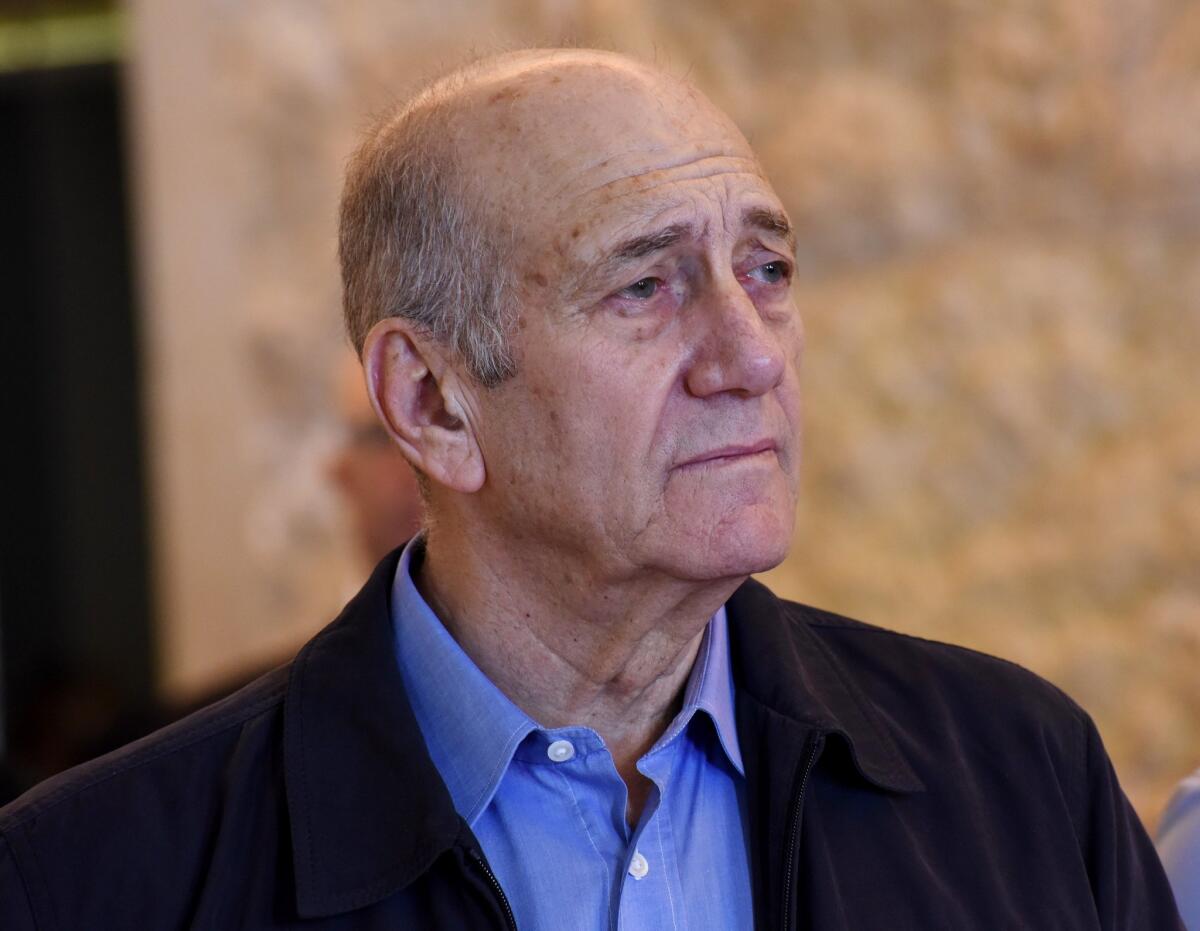 Former Israeli Prime Minister Ehud Olmert leaves the courtroom of the Supreme Court after the court ruled on his appeal in the Holyland corruption case in Jerusalem. He began serving a 19-month prison sentence on Monday.