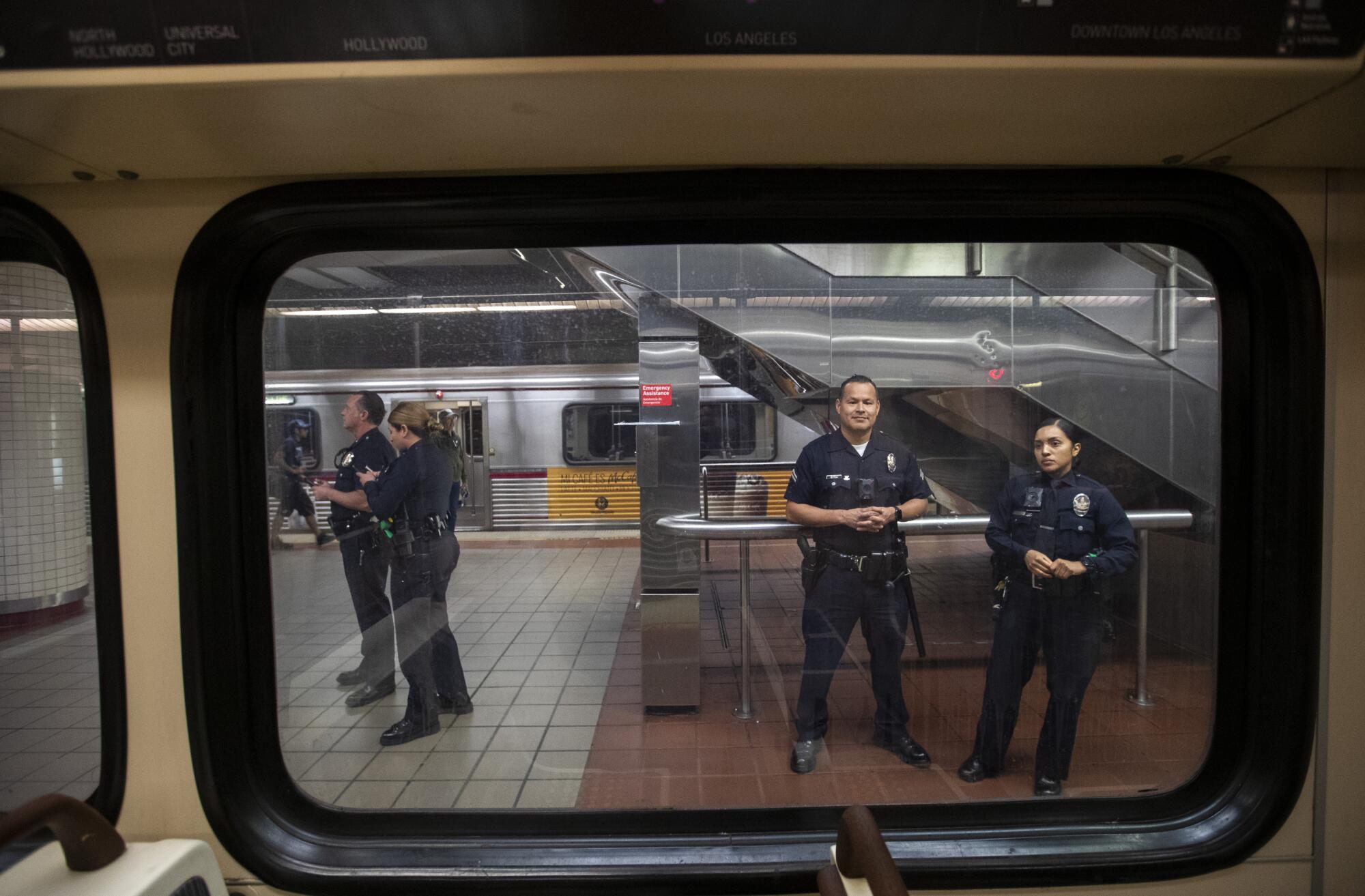 LAPD officers patrol inside the 7th Street/Metro Center subway station in Los Angeles. 