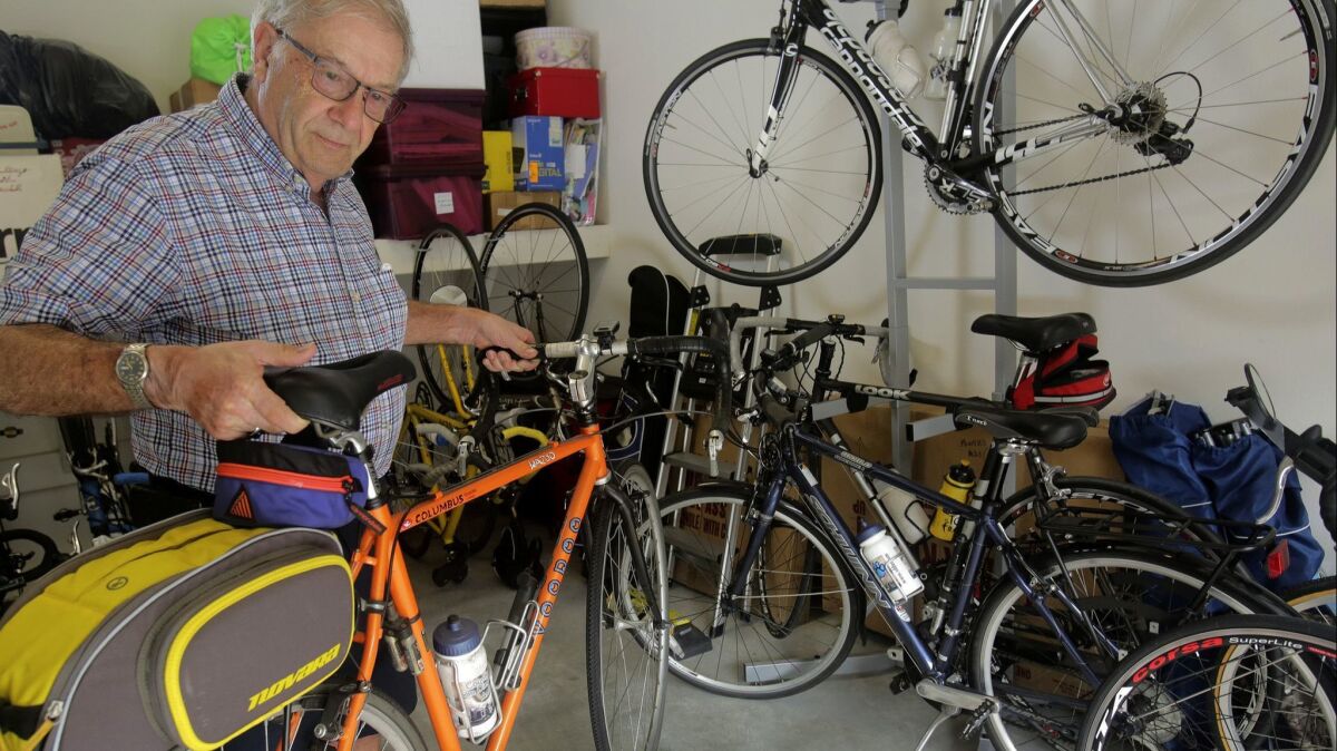 Dr. Daniel Marks holds his 24-pound Voodoo touring bike, which is designed to carry small travel bags