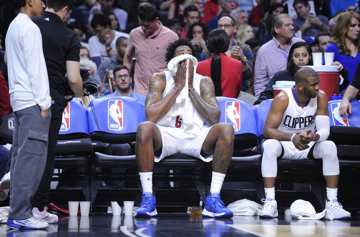 Clippers DeAndre Jordan and Chris Paul sit on the bench in the fourth quarter of a March 13 game against the Cleveland Cavaliers at Staples Center.